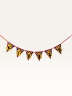 Paper Party Studio personalised race car birthday bunting with checkered flag pattern and yellow flame letter badges.