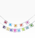 Paper Party Studio rainbow paper bunting banner with "HAPPY" and "BIRTHDAY" spelled out in colourful letters on white flags with dashed borders.