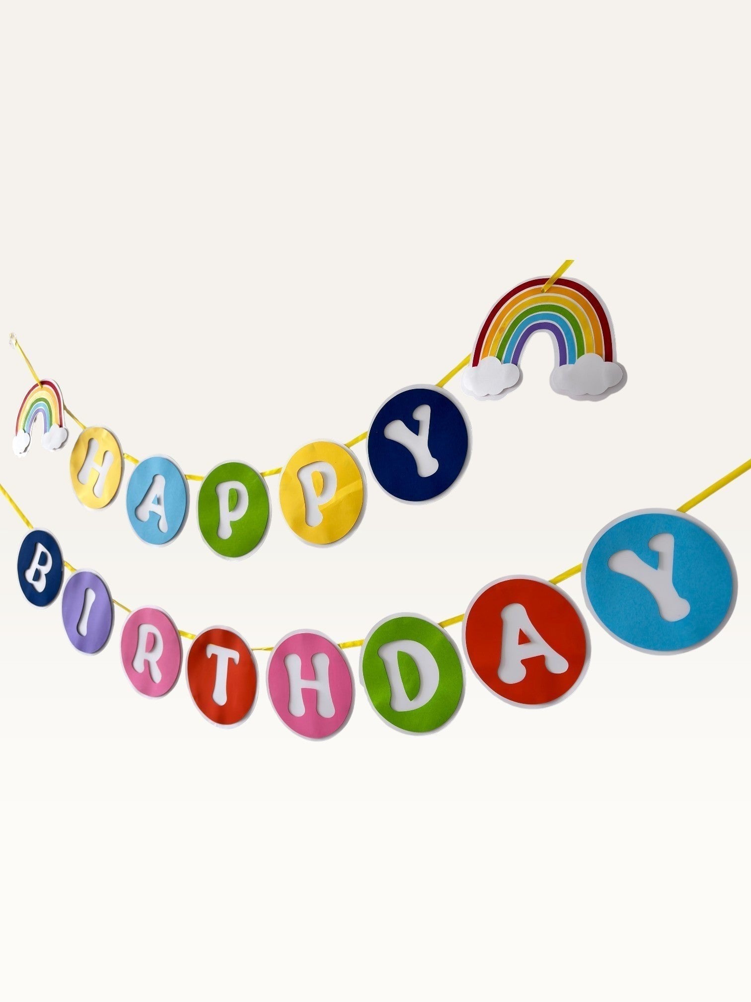 Paper Party Studio rainbow birthday banner with colourful paper circles, white letters, and cloud accents.