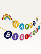 Paper Party Studio rainbow Happy Birthday banner with colourful paper circles and cloud accents for kids parties.