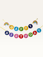 Paper Party Studio rainbow circle Happy Birthday banner with cloud accents on yellow string for kids party decor.
