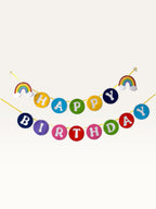 Paper Party Studio rainbow Happy Birthday banner with colourful circular letters and unicorn-themed cloud accents