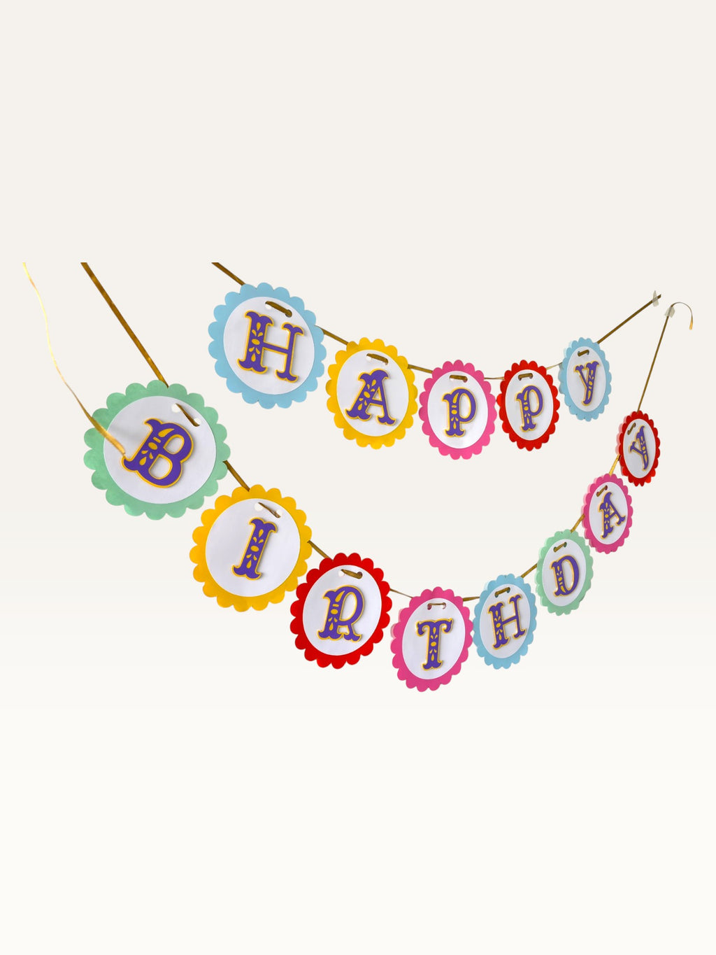 Paper Party Studio Happy Birthday banner featuring rainbow scalloped cardstock circles with purple and gold lettering.