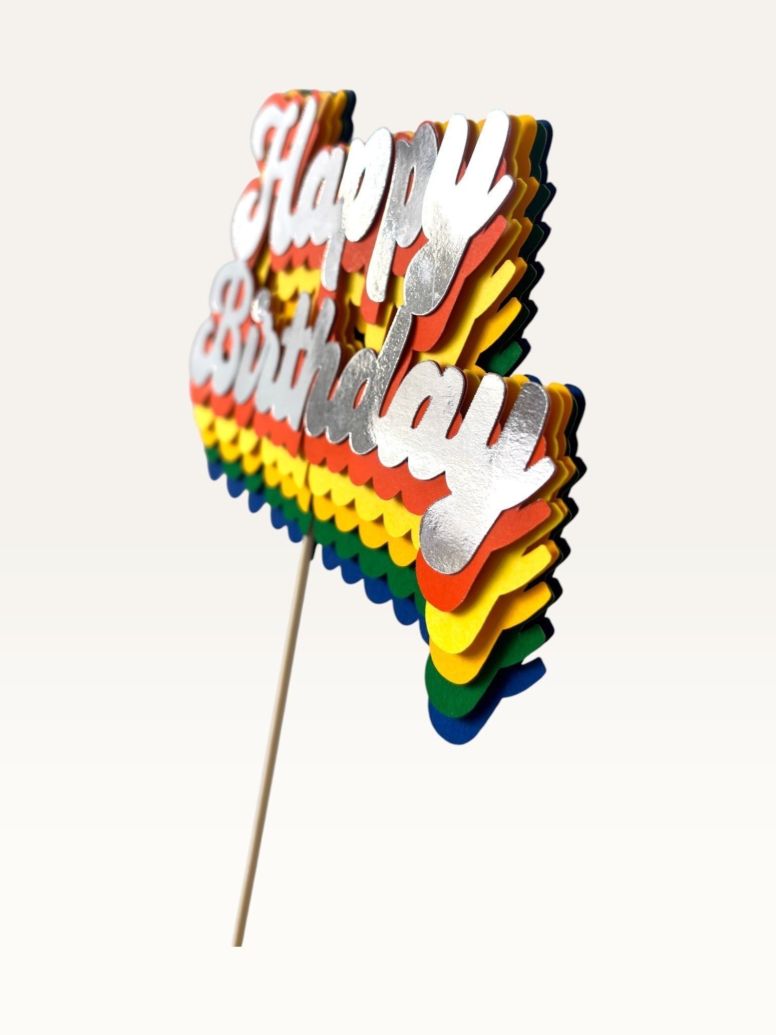 Paper Party Studio retro Happy Birthday cake topper with layered rainbow cardstock and silver script lettering.