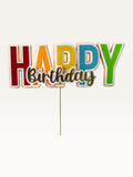 Paper Party Studio multicolour block letter Happy Birthday cake topper with gold script and white outline on a pick