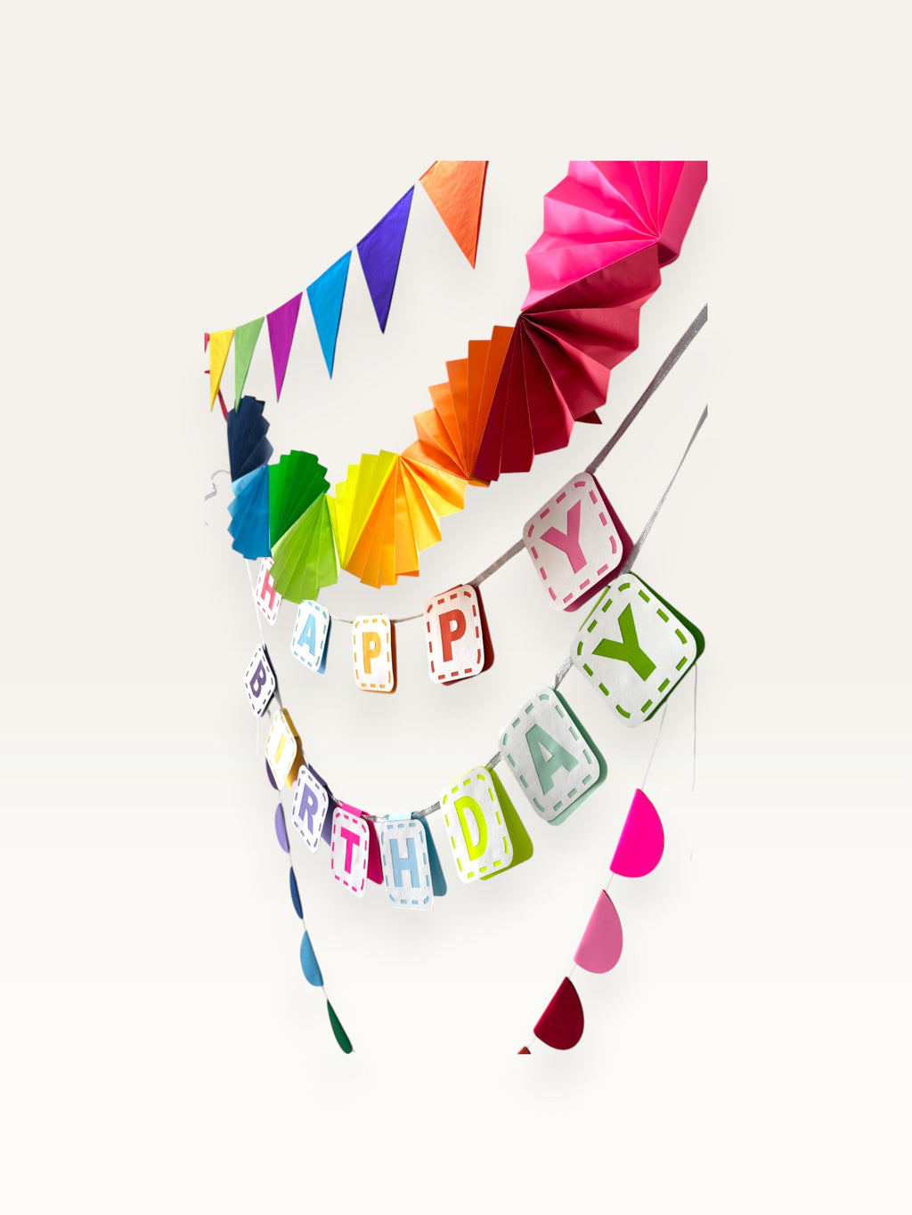 Paper Party Studio rainbow birthday decoration set featuring a Happy Birthday banner, triangle bunting, and paper fans.