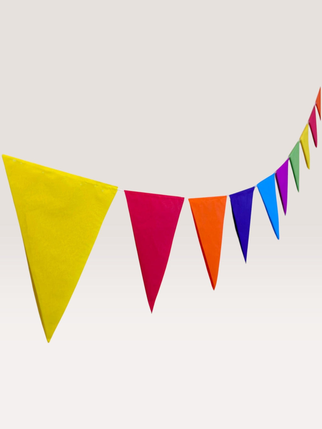 Paper Party Studio rainbow tissue paper pennant bunting with triangle flags in yellow, pink, orange, blue, purple, and green.