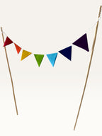 Paper Party Studio rainbow pennant cake topper with colourful triangle flags on two bamboo sticks for party cakes