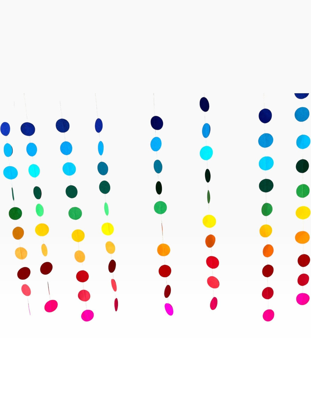 Paper Party Studio rainbow gradient circle curtain backdrop with multiple strands of paper circles in blue, green, yellow, orange, red, and pink.