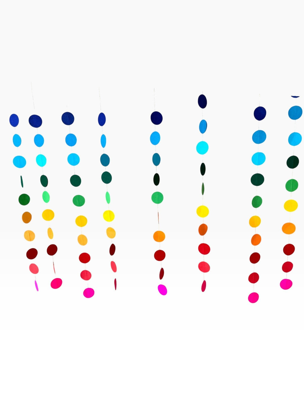 Paper Party Studio rainbow circle curtain backdrop with strands of blue, green, yellow, orange, red, and pink paper circles.