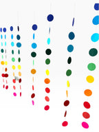 Paper Party Studio rainbow circle curtain backdrop with strands of blue, green, yellow, orange, red, and pink paper circles.