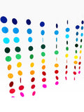 Paper Party Studio rainbow circle curtain backdrop with strands of blue, green, yellow, orange, red, and pink paper circles.