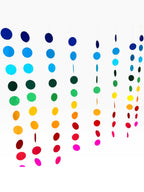 Paper Party Studio rainbow circle curtain backdrop with strands of blue, green, yellow, orange, red, and pink paper circles.