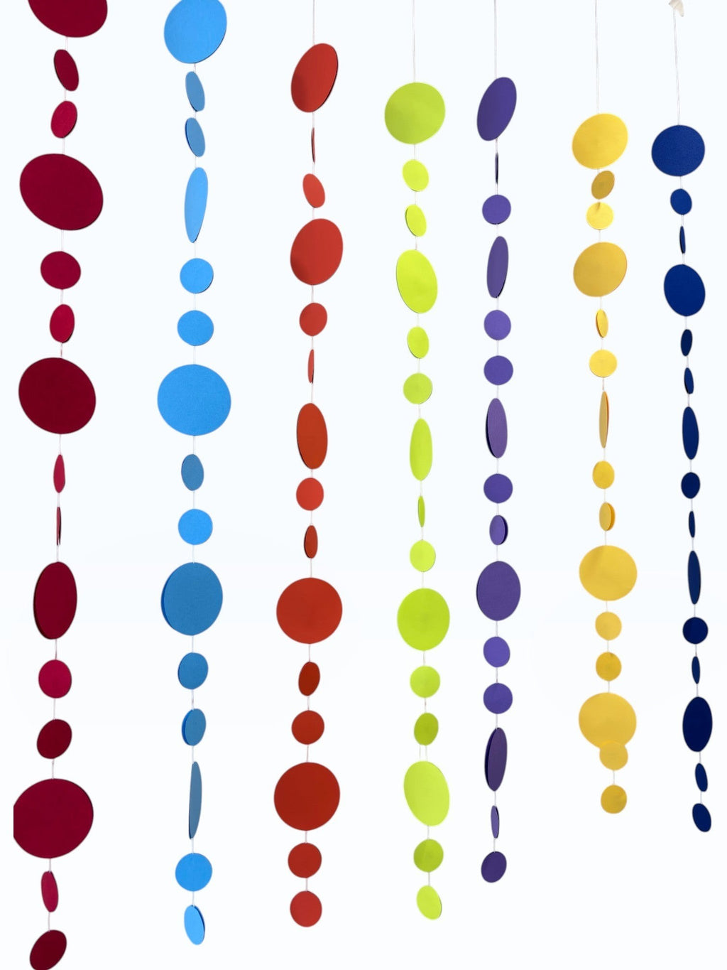 Paper Party Studio rainbow circle garland with graduated sizes and bright tones, made of premium cardstock.