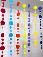Paper Party Studio rainbow circle garland with graduated paper dots in red, blue, orange, yellow, green, and purple.