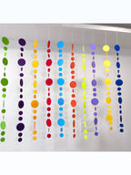 Paper Party Studio rainbow circle garland with 10 strings of graduated paper dots in vibrant colors, perfect for parties and backdrops.