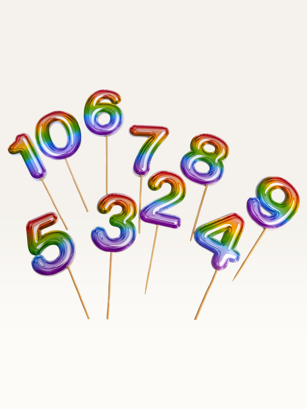 Paper Party Studio rainbow foil number cake toppers on bamboo sticks for birthday celebrations.
