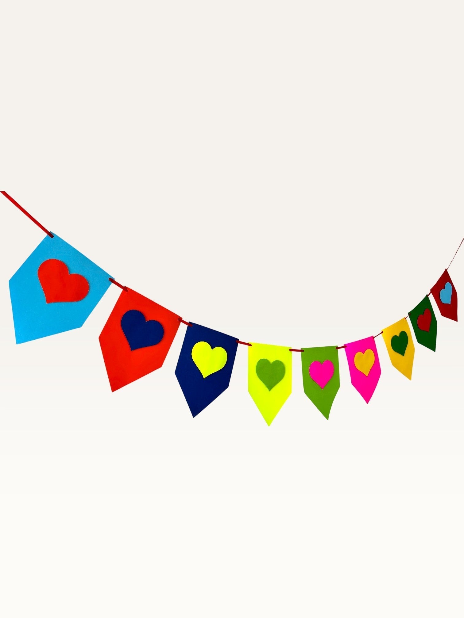 Paper Party Studio rainbow heart bunting made from layered cardstock for birthday and party decorations.