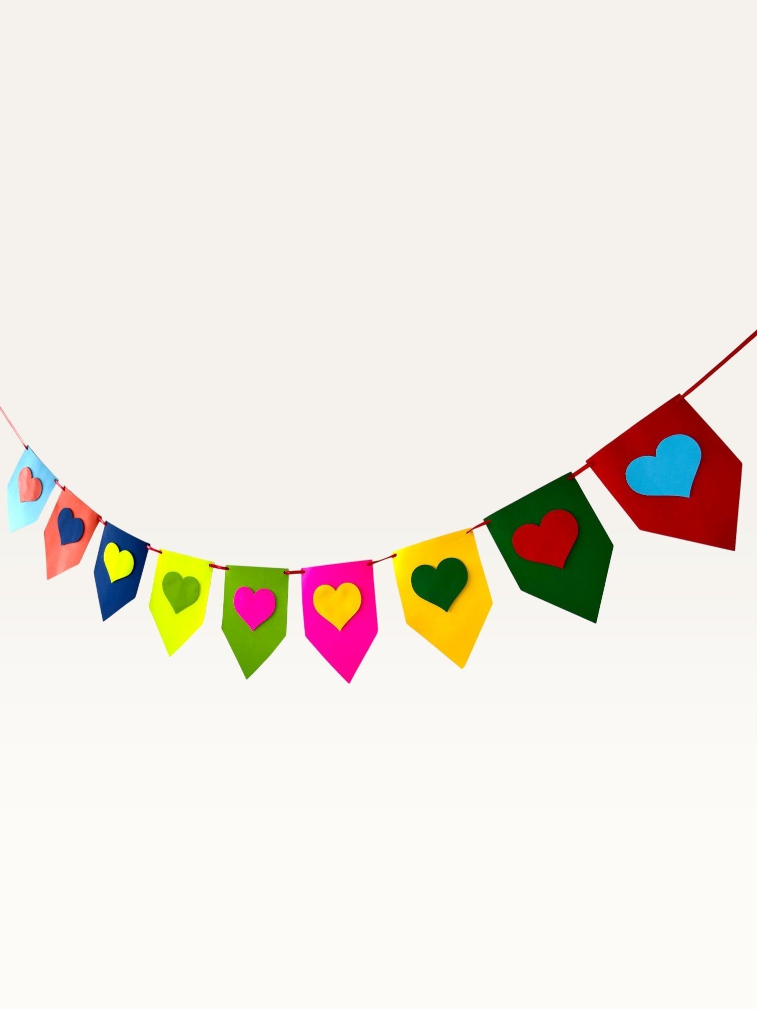 Paper Party Studio rainbow heart bunting made from layered cardstock for birthday party or nursery decor.