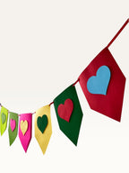 Paper Party Studio rainbow heart bunting made from layered cardstock for birthday and party decorations.
