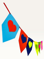Paper Party Studio rainbow heart bunting made from layered cardstock for birthday and party decorations.