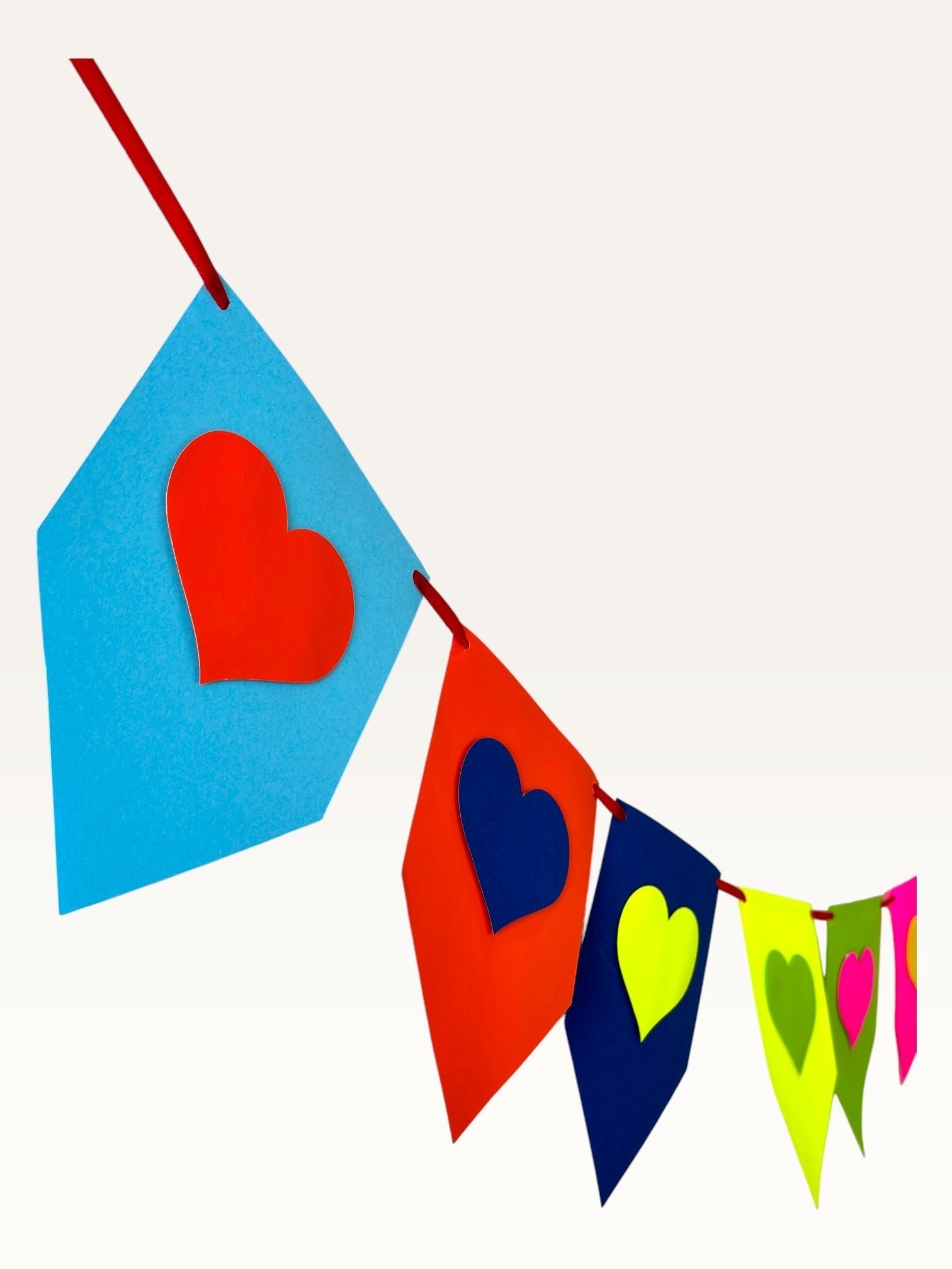 Paper Party Studio rainbow heart bunting made from layered cardstock for birthday and party decorations.