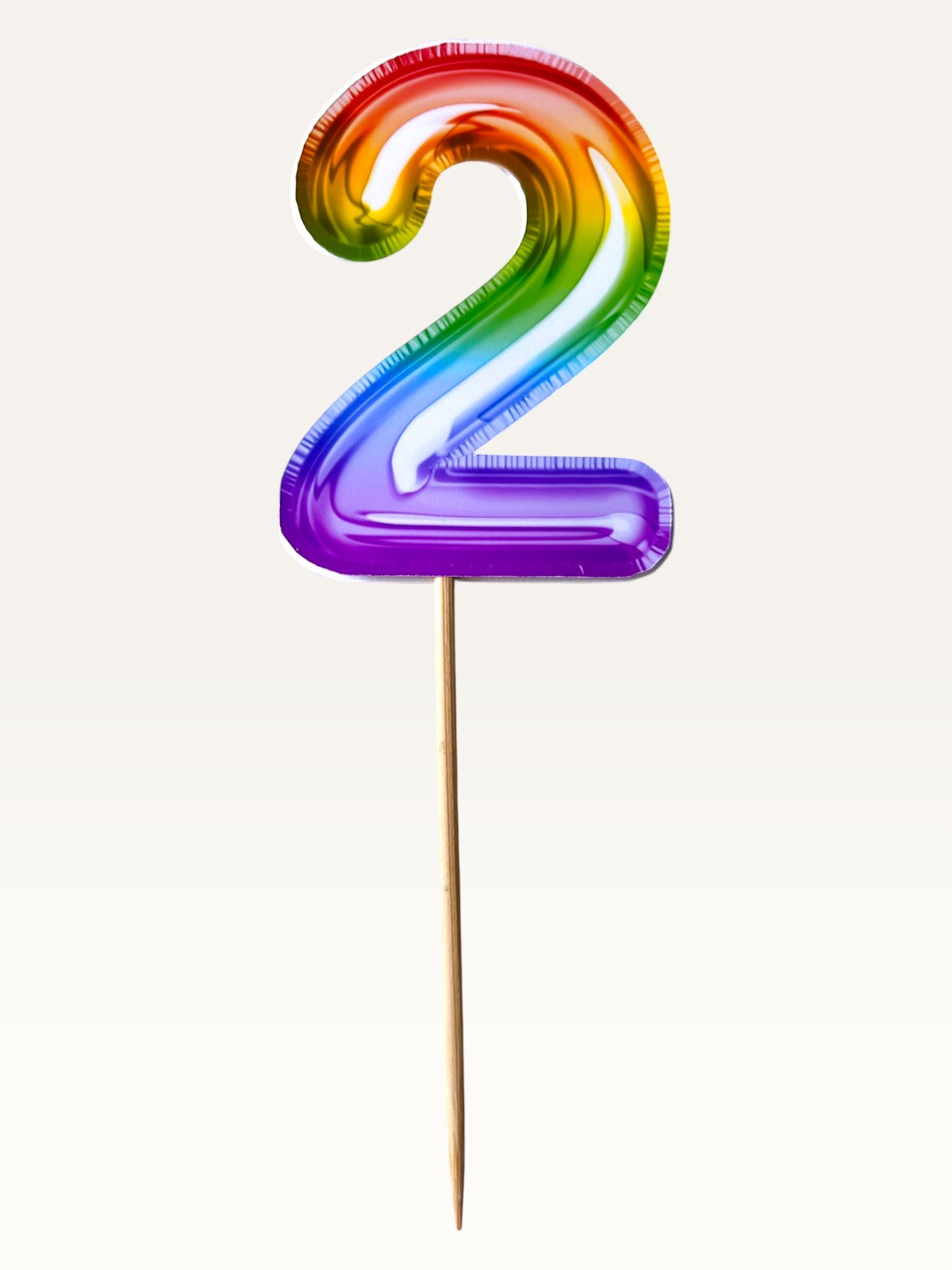 Paper Party Studio rainbow foil number 2 cupcake topper on a bamboo stick with double-sided metallic finish.