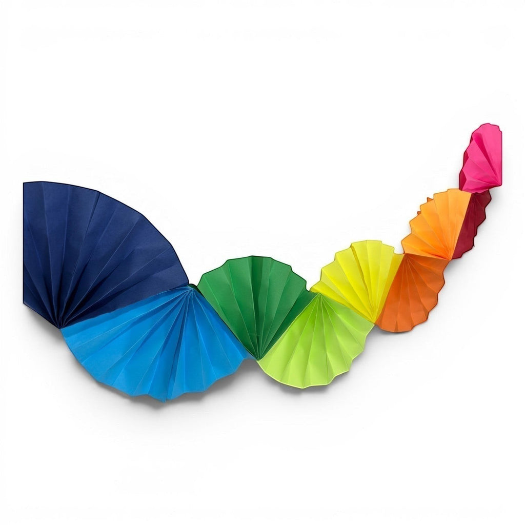 Paper Party Studio rainbow Colorwave Garland made of handcrafted cardstock paper fans for party wall decorations.