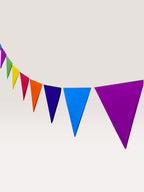 Paper Party Studio rainbow tissue paper pennant bunting with triangle flags in purple, blue, dark blue, orange, red, yellow, green, and pink.