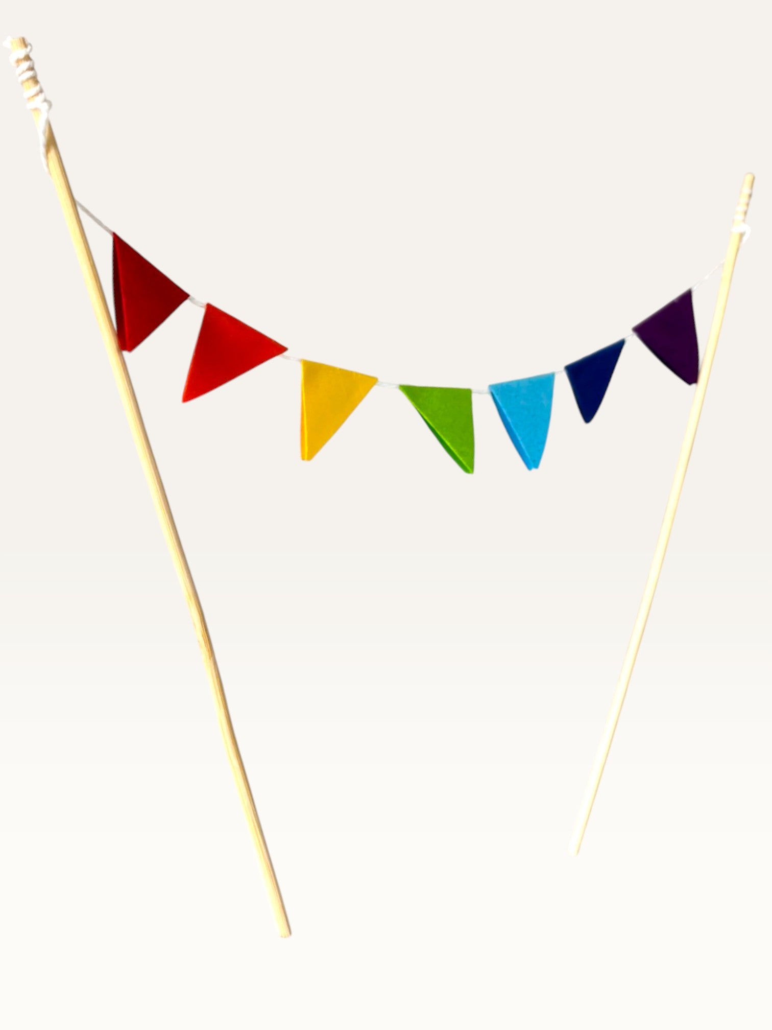 Paper Party Studio rainbow pennant cake topper with mini colourful triangle flags on two slim bamboo sticks