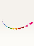Paper Party Studio rainbow scallop garland featuring vibrant cardstock half-circles for nursery or party decoration