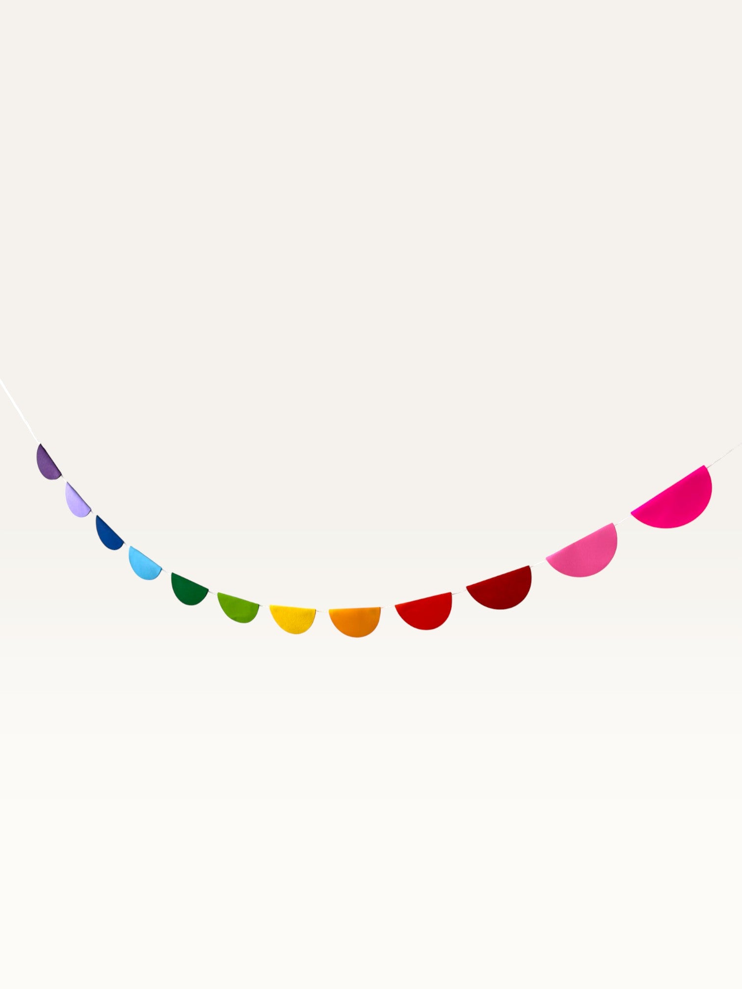 Paper Party Studio rainbow scallop garland featuring vibrant cardstock half-circles for nursery or party decoration