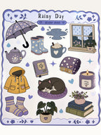 Paper Party Studio Rainy Day sticker sheet featuring cozy illustrations of rain boots, a cat, and a yellow raincoat.