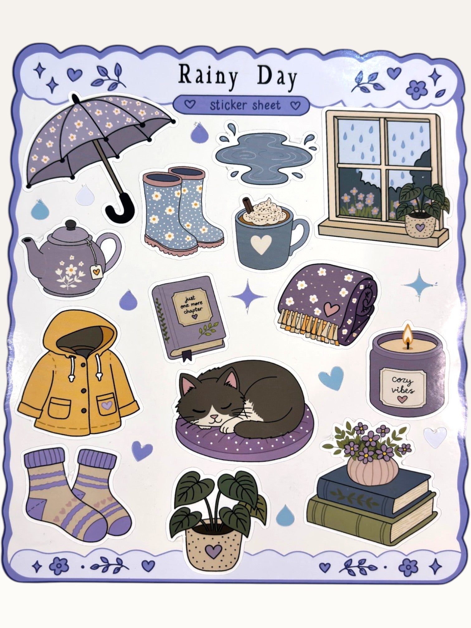 Paper Party Studio Rainy Day sticker sheet featuring cozy illustrations of rain boots, a cat, and a yellow raincoat.