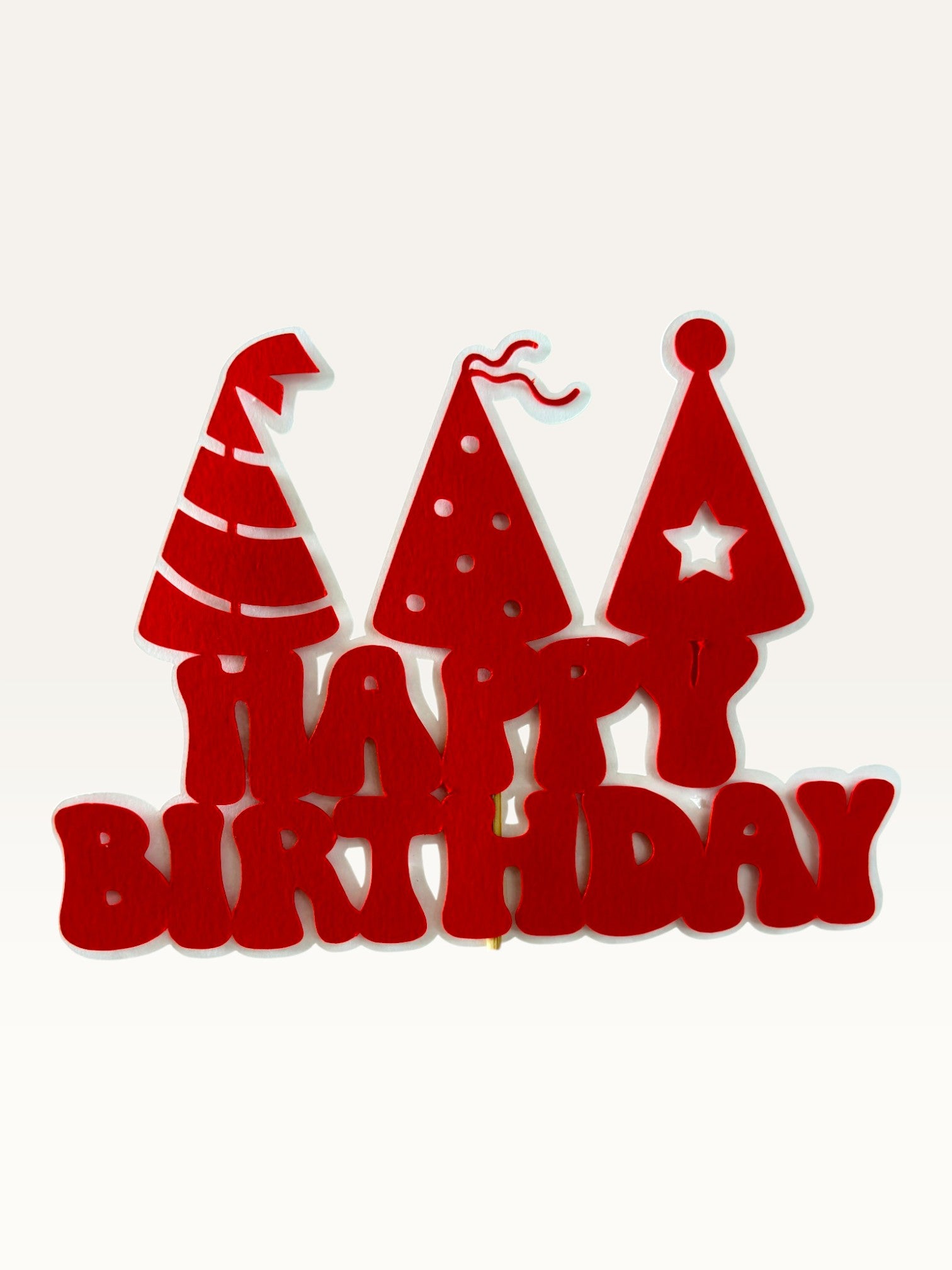Paper Party Studio red Happy Birthday cake topper with three party hat cut-outs on a wooden pick.