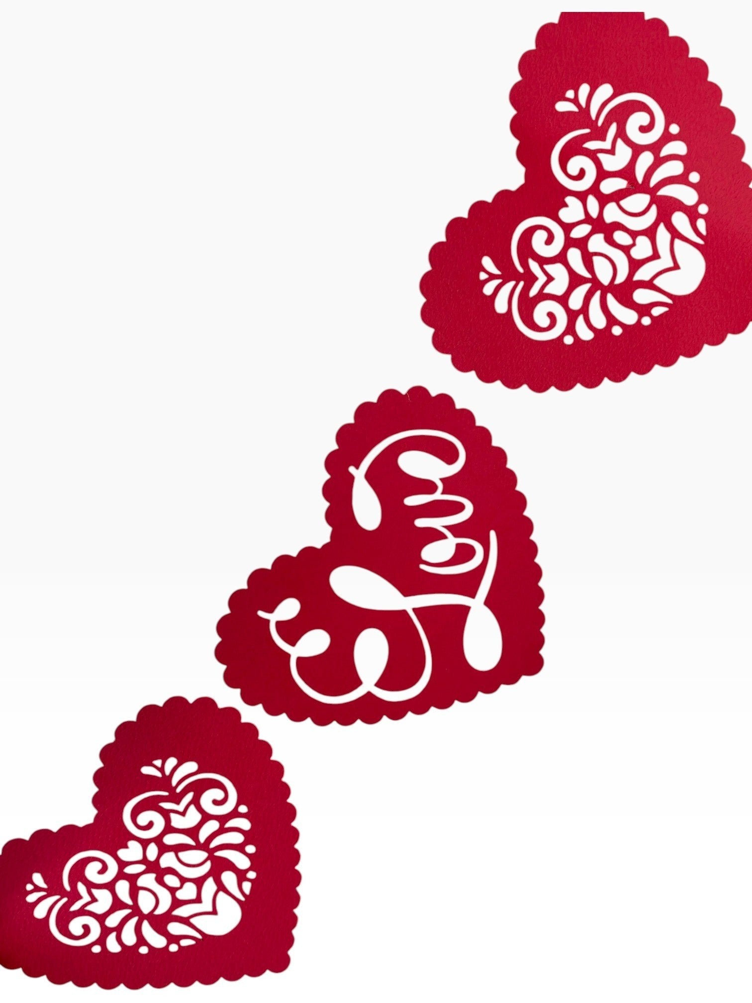Paper Party Studio red heart bunting with floral cut-outs and cursive 'Love' text, scalloped edges.