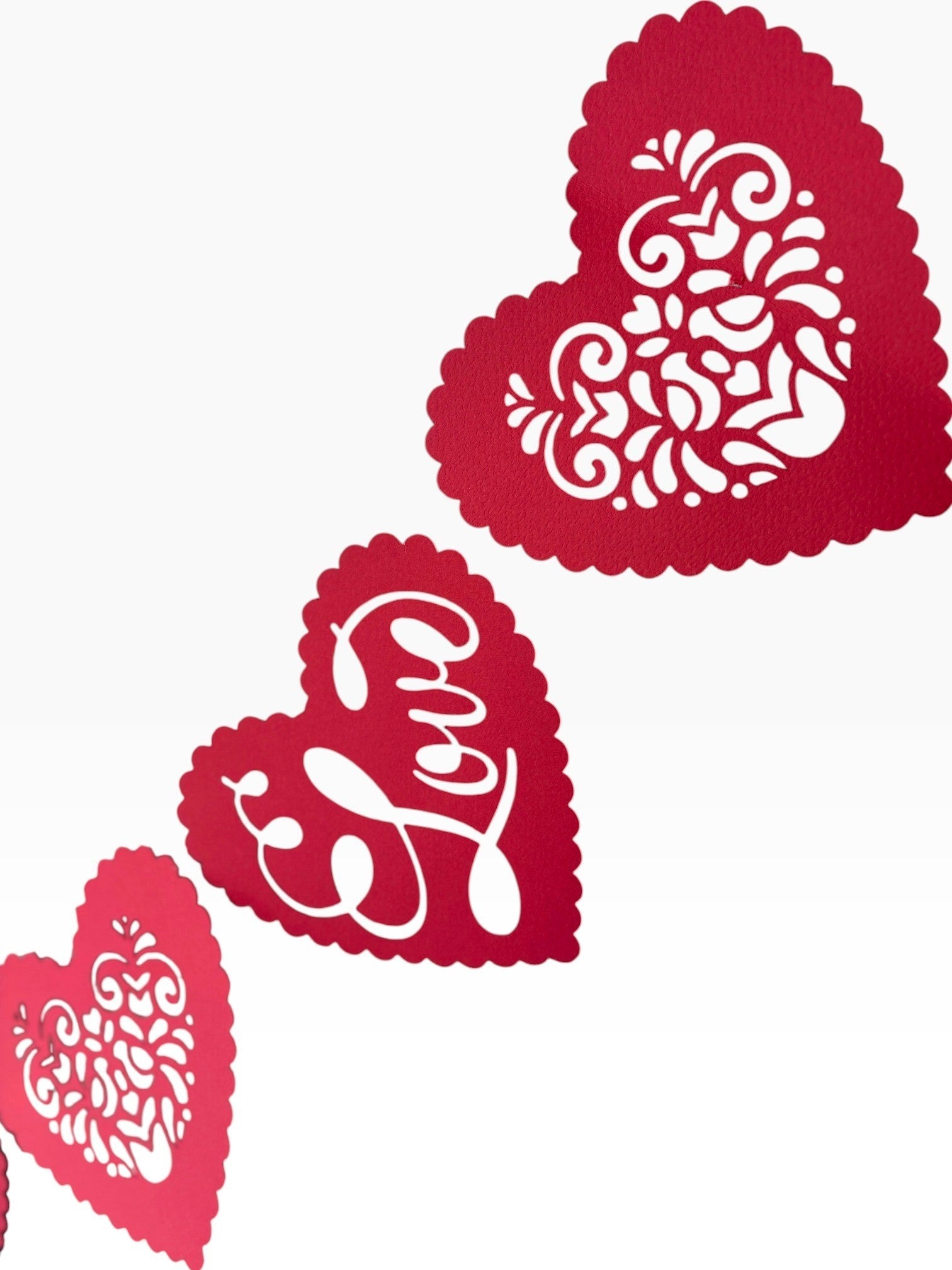 Paper Party Studio red heart bunting with floral cut-outs and "Love" script, perfect for Valentine's Day.