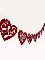 Paper Party Studio red heart bunting with scalloped edges, floral cut-outs, and cursive Love script for weddings.
