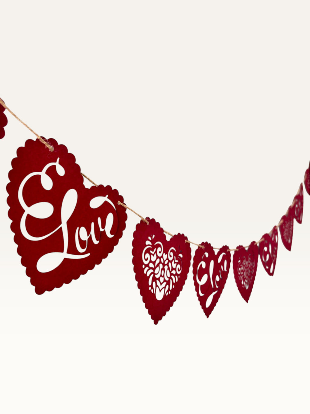 Paper Party Studio red heart bunting with scalloped edges, floral cut-outs, and cursive Love text for romantic decor.