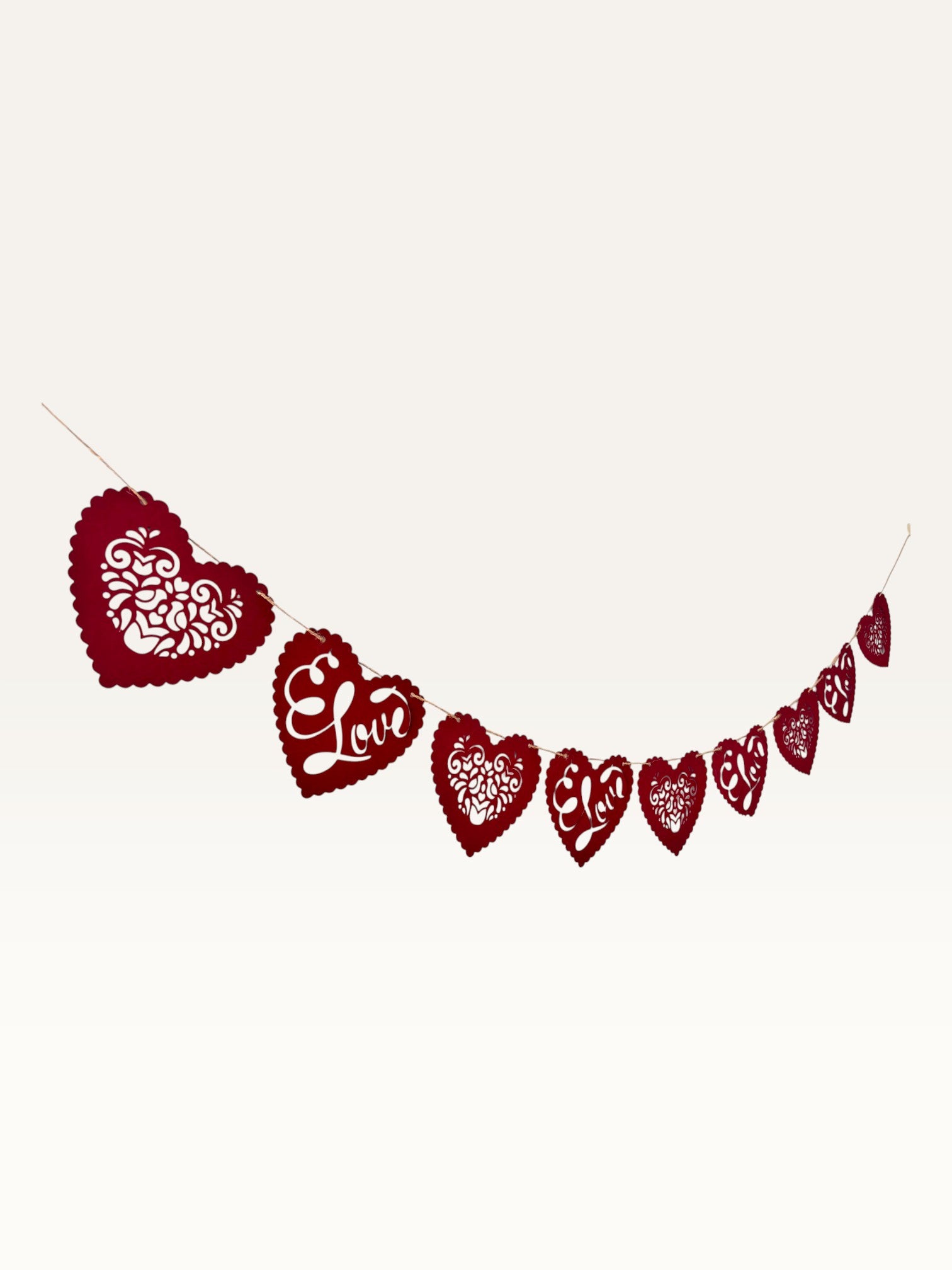 Paper Party Studio red heart bunting with scalloped edges, floral cut-outs, and cursive Love script for romantic decor.