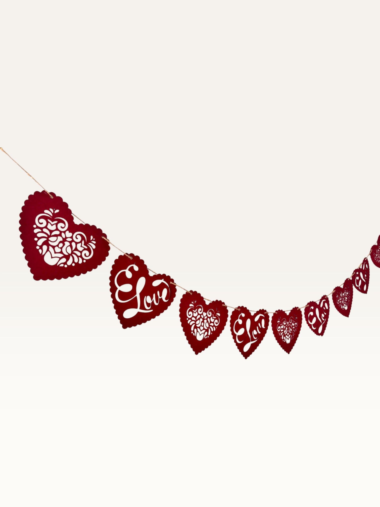 Paper Party Studio red heart bunting with intricate floral cut-outs and cursive Love text for romantic decor.