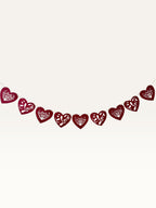 Paper Party Studio red heart bunting with scalloped edges, floral cut-outs, and cursive Love script for weddings.