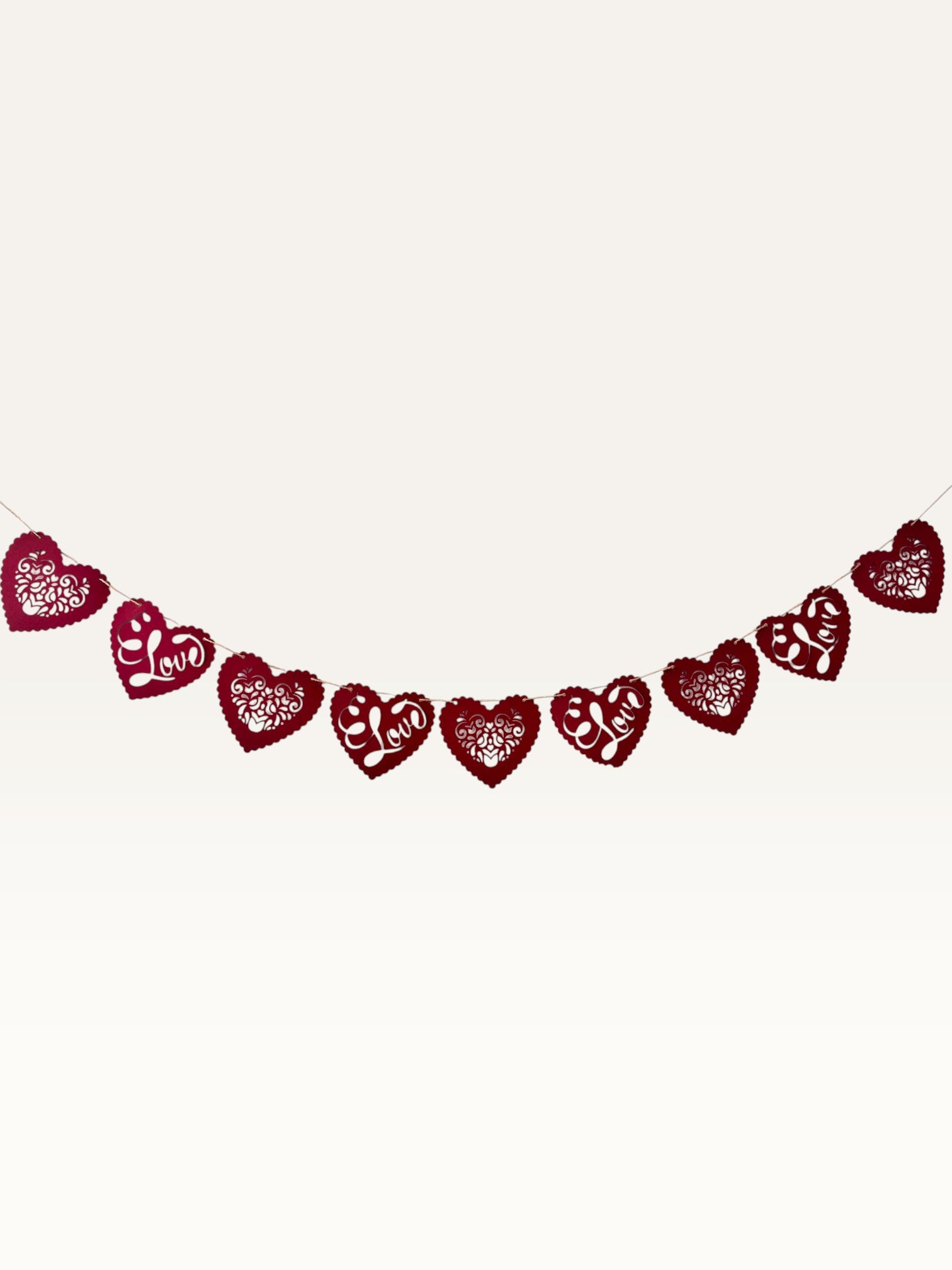 Paper Party Studio red heart bunting with scalloped edges, floral cut-outs, and cursive Love script for weddings.