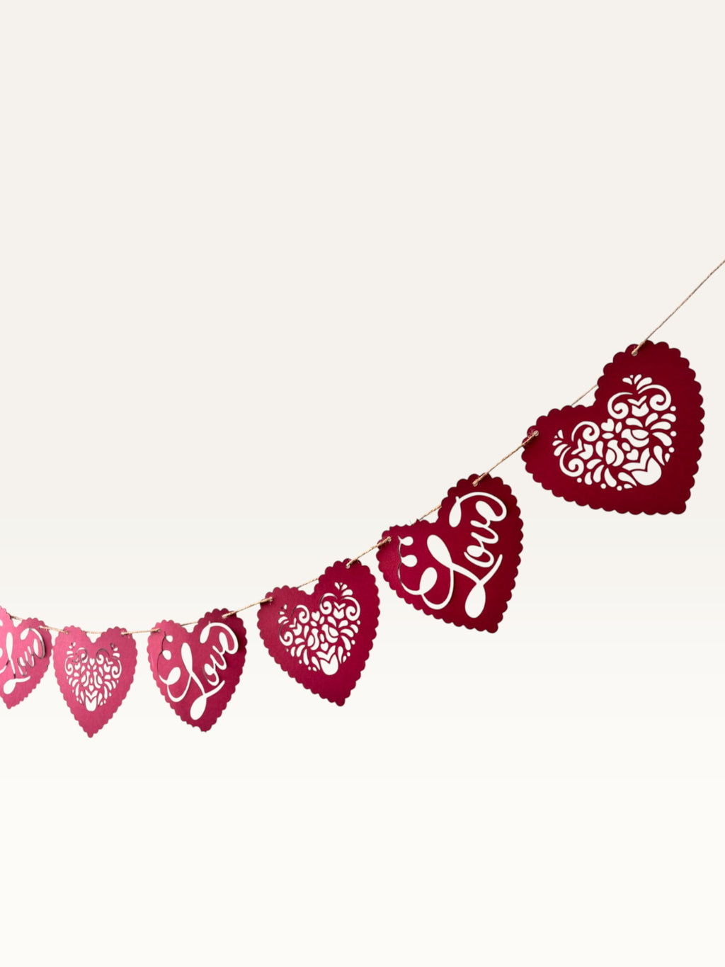 Paper Party Studio red heart bunting with scalloped edges, floral cut-outs, and cursive Love script for romantic decor.