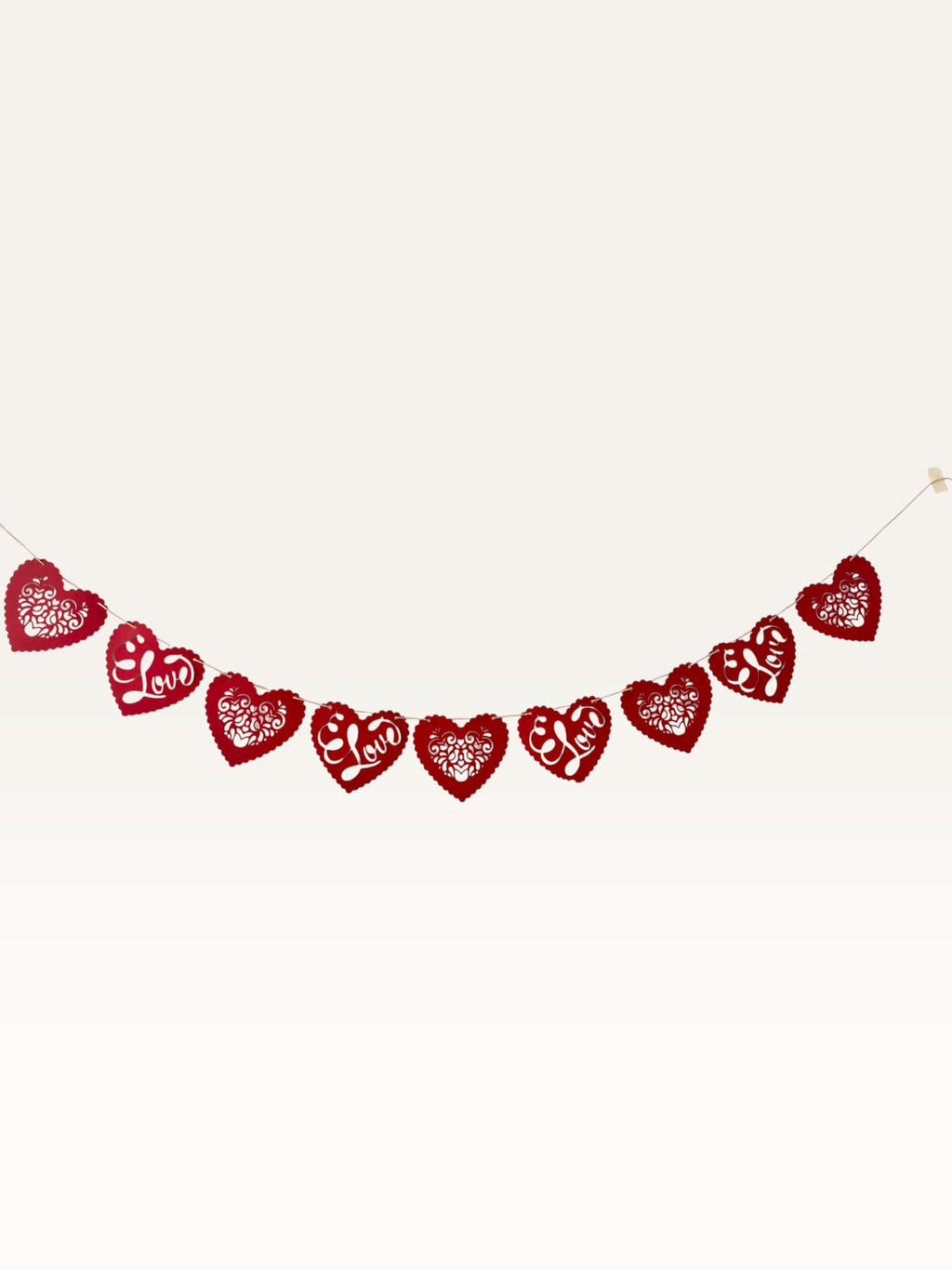 Paper Party Studio red heart bunting with intricate floral cut-outs and cursive Love script for romantic decor.