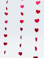 Paper Party Studio red heart garland, set of 10 strings with mini heart cut-outs, perfect for Valentine's Day or weddings.