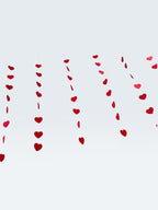 Paper Party Studio red heart garland, a set of 10 strings with mini heart cut-outs, perfect for Valentine's Day or weddings.