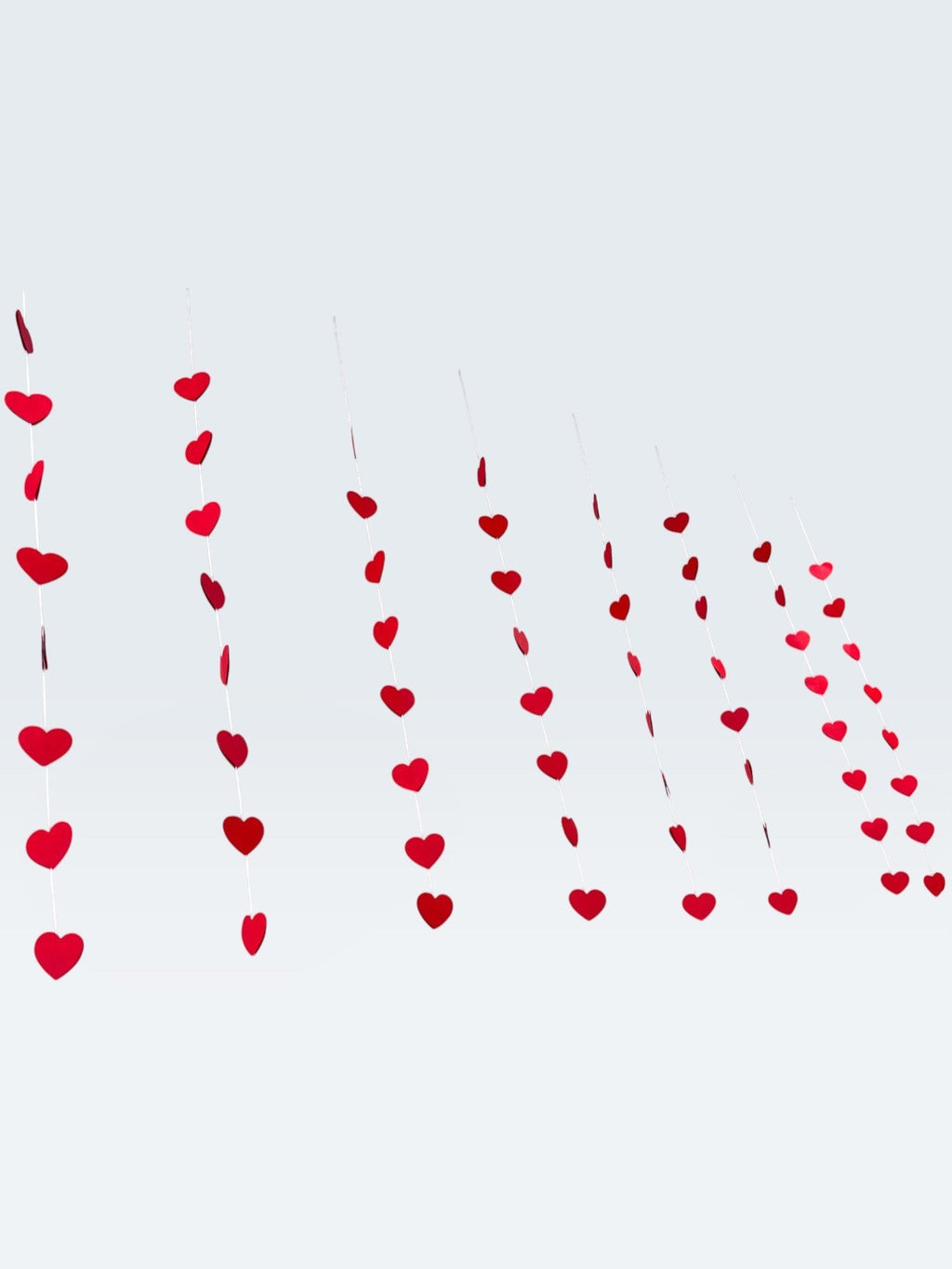 Paper Party Studio red heart garland, set of 10 strings with mini heart cut-outs, perfect for Valentine's Day or weddings.