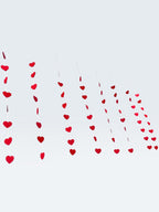 Paper Party Studio red heart garland, set of 10 strings with mini heart cut-outs, perfect for Valentine's Day or weddings.