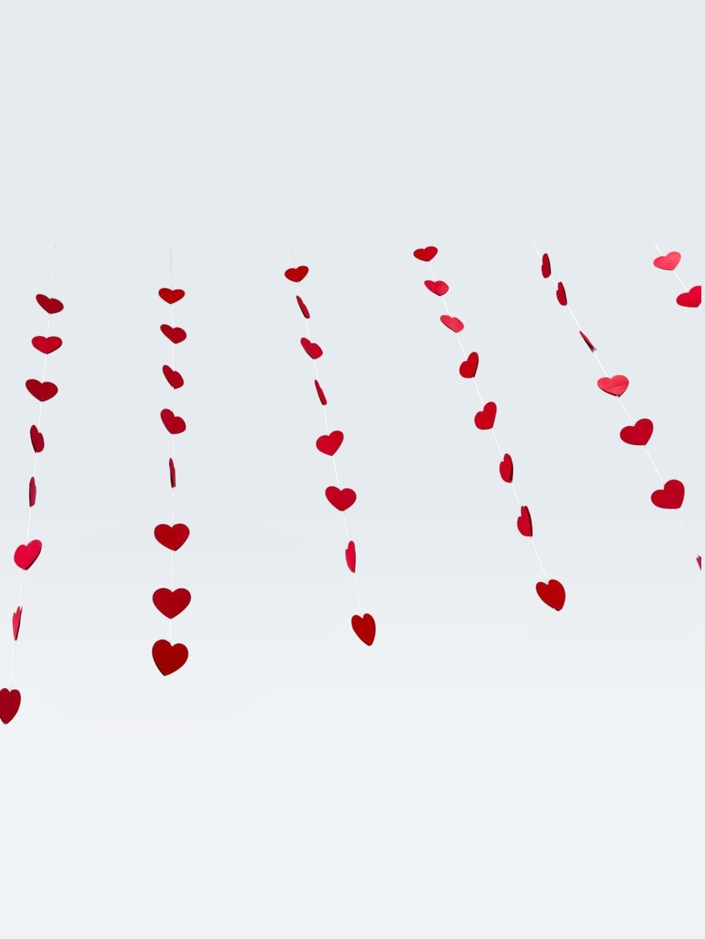 Paper Party Studio red heart garland strings for romantic wedding, anniversary, or Valentine's Day party backdrop.